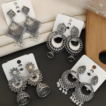 pairs of traditional oxidized silver-toned Indian Jhumka earrings
